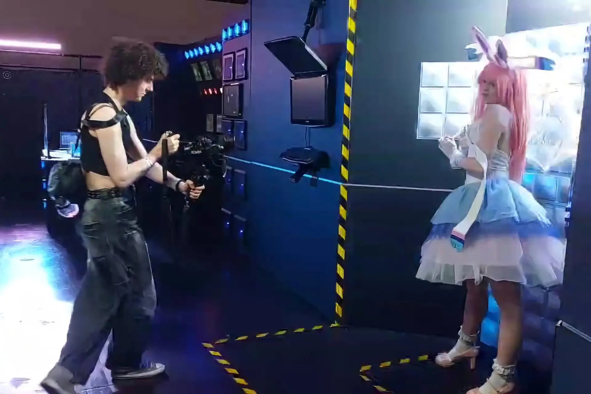 This picture shows Melly filming a cosplay with her gimbal and camera. The cosplay is wearing a pokemon cosplay and stands in a room full of flashing lights.